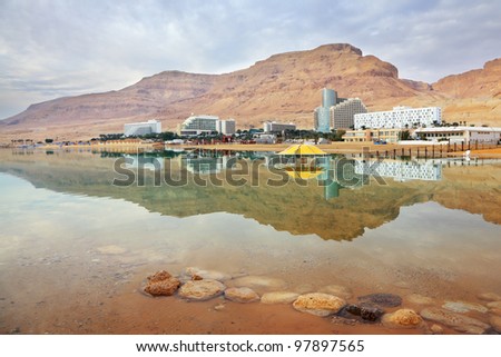 Winter in the Dead Sea. The comfortable high-rise hotels are reflected in the sea smooth water