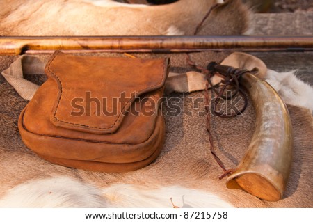 American Revolutionary War weapons. A vintage leather satchel, flintlock gun and powder horn from the war of independence on public display at a North Carolina heritage festival.