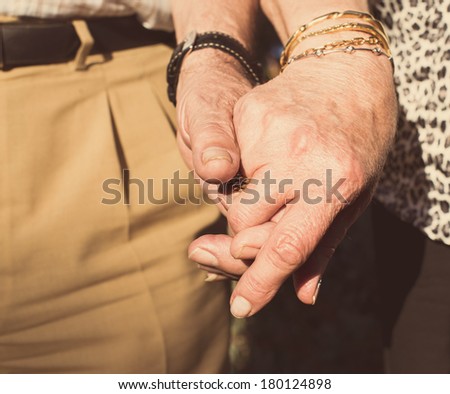 Elderly couples holding hands - close up