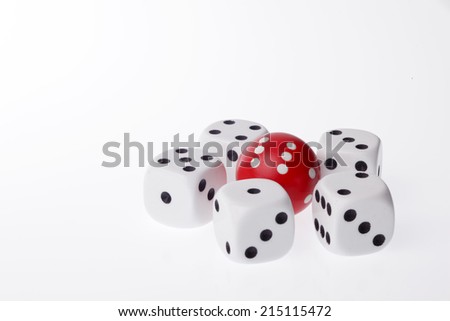 Five white dices and one round red dice