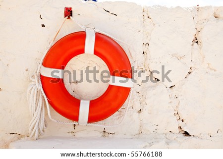 Life Preserver hanging on wall with rope attached
