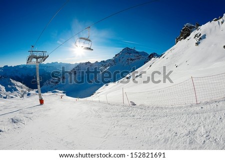 Ski slope with chairlift and sunshine