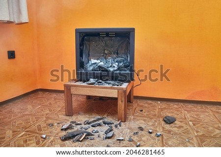 Olt tube TV set smashed with an axe, glass CRT imploding, pieces in the room everywhere Photo stock © 