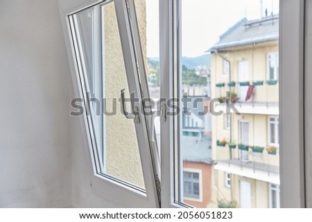 Window tilt open in a city apartment, letting in fresh air Stock foto © 