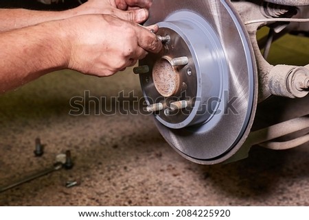 Changing brake rotor disc on a car in the garage 商業照片 © 