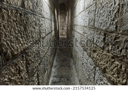 Narrow passage between castle walls made of stone blocks Photo stock © 