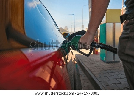 Similar – Foto Bild Detail einer Zapfsäule in einer Tankstelle. Verschiedene Betankungspistolen.