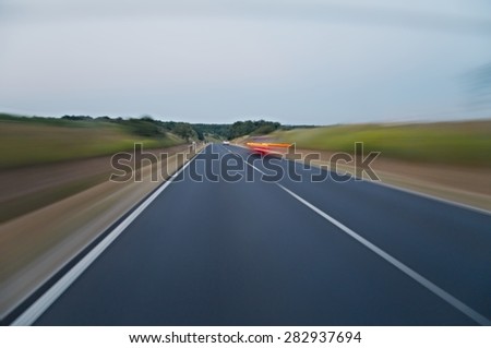 Motion blurred road viewed from a fast car
