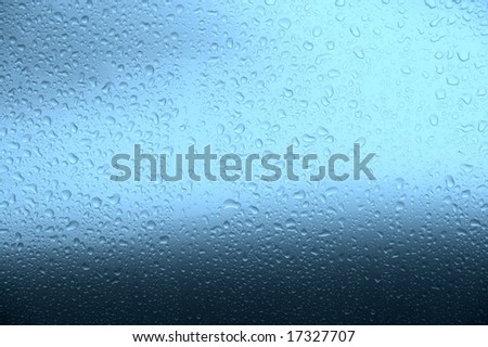 Many small raindrops on blue background