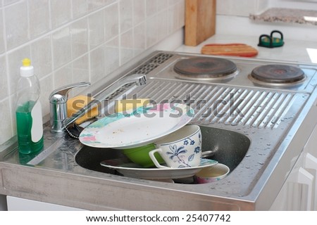 A pile of dirty dishes in the dishwasher