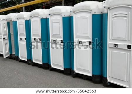 Row of portable toilets at an outdoor event