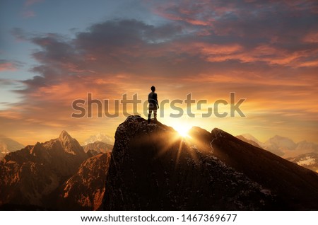 A man standing on top of a mountain as the sun sets. Goals and achievements concept photo composite. Imagine de stoc © 