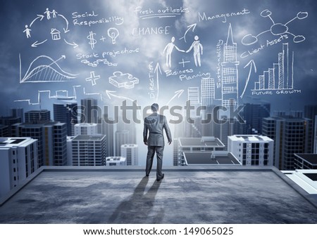 Business Ideas - conceptual. A businessman watching the city with big ideas.