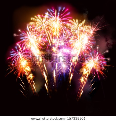 Colourful golden and pink fireworks display for celebrations.