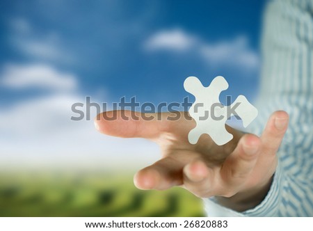 A man holding a puzzle piece.