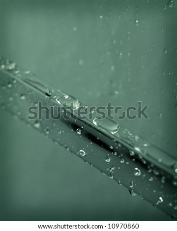 green water drops on shower door rail