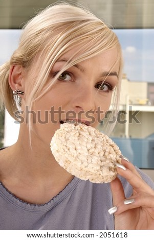 blond, young girl, woman eating rice cracker