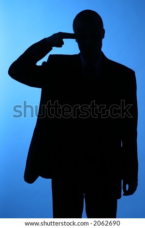elegant man, businesman in  a suit pointing to his temple-sillhuette