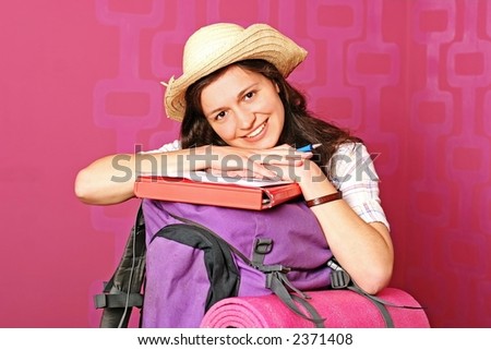 young backpacker setting for a journey around the world - on pink