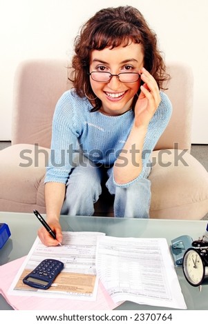 young woman doing some paperwork-filling tax form