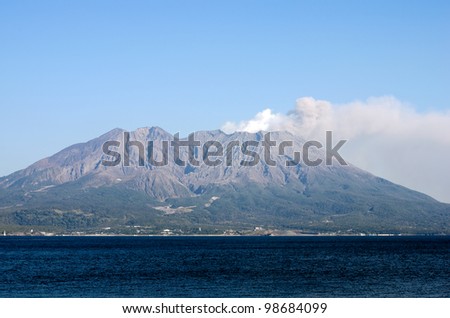 Active volcano and volcanic plume facing the sea