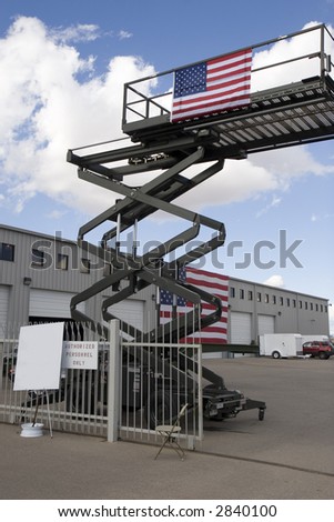 an industrial scissor lift with american flag