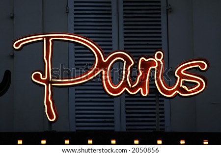 Paris neon sign in front of window shutters