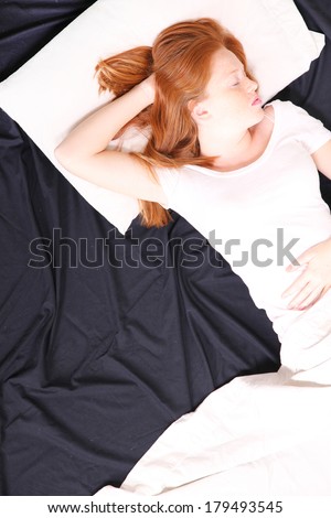 A young adult Woman sleeping on bed.