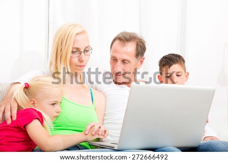 Happy family sitting together on the couch - Stock Image - Everypixel