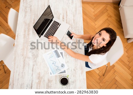 A young, beautiful business woman working from her home office