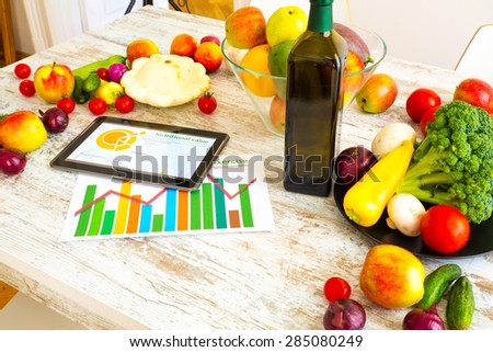 Organic food and a Tablet PC showing information about healthy nutrition and phytochemical composition.