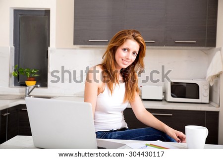 Portrait of a brunette girl working in the kitchen.