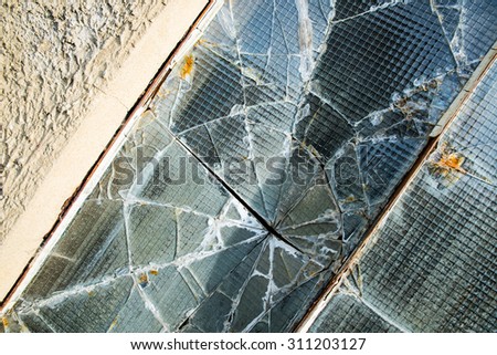 A broken industrial security window.