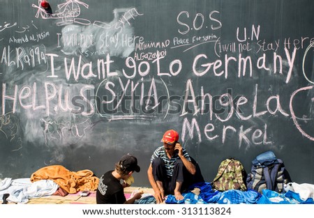 BUDAPEST, HUNGARY - SEPTEMBER 04: Syrian refugees demand help from Germany written on a wall at the Train Station Keleti Palyudvar on September 04, 2015 in Budapest, Hungary.
