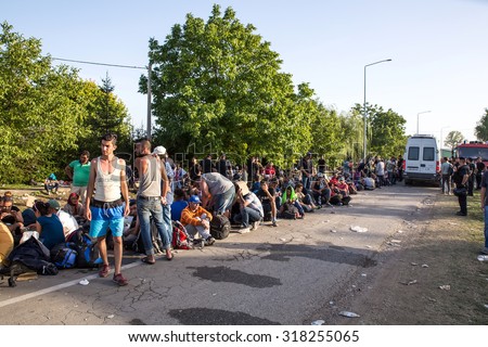 TOVARNIK, CROATIA - SEPTEMBER 18: Stranded Refugees form a waiting line in order to get a transported further towards northern Europe on September 18, 2015 in Tovarnik, Croatia.