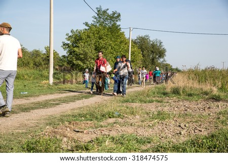 TOVARNIK, CROATIA - SEPTEMBER 18: Refugees cross the uncontrolled border from Serbia to Croatia on September 18, 2015 in Tovarnik, Croatia.