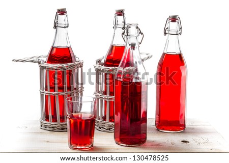 Bottles with red juice on white background