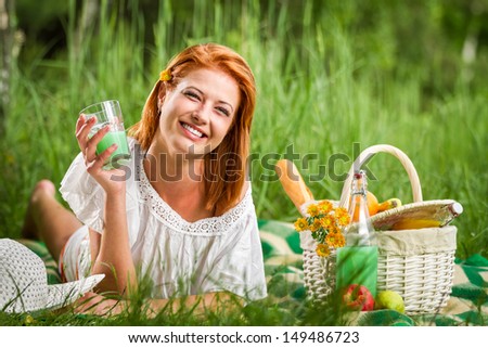 Happy young woman on picnic in summer