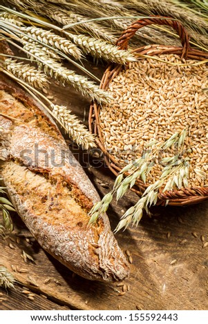 Fresh baguette with cereal grains in a basket