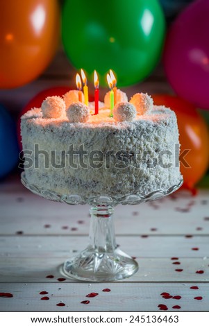 Coconut cake with candles on birthday