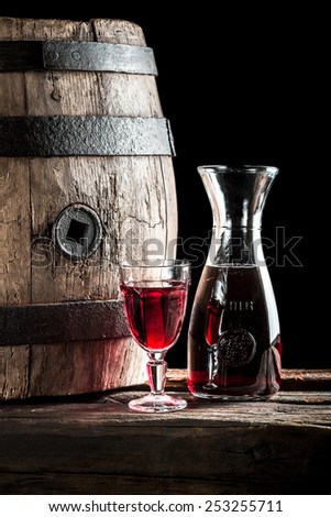 Red wine in glass and carafe in the old winery
