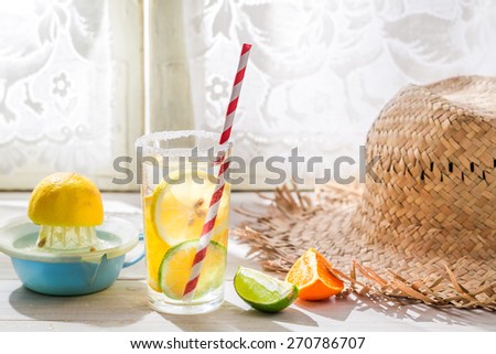 Tasty drink with straw and fruits