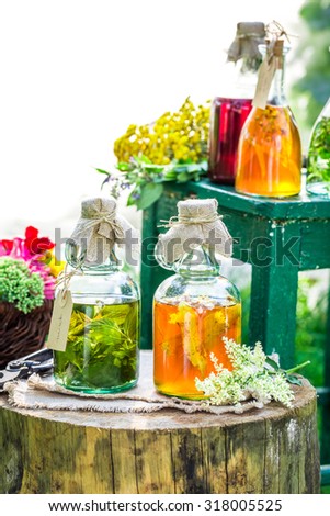 Healing herbs in bottles with alcohol and herbs