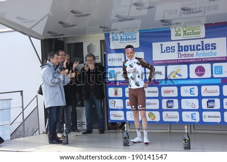 VALENCE, FRANCE - MAR 02: Romain Bardet, winner of La Classic Drome UCI Europe Tour Pro Race receiving flowers in podium on March 02, 2014 in Valence, Drome, France.