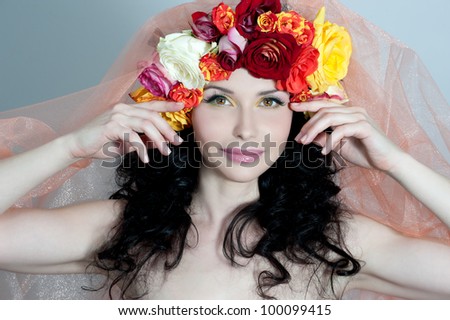 Beautiful woman with roses flowers in her hair. Bride