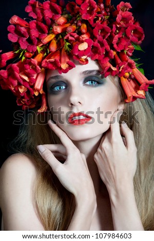 portrait of beautiful woman model face with creative make-up and red flowers