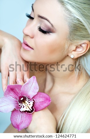 woman with bright pink orchid