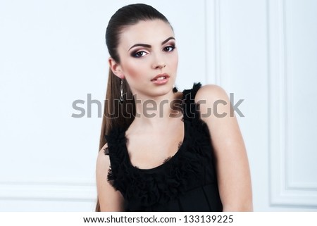 Beautiful woman with evening make-up and evening hairstyle. Jewelry and Beauty. Fashion photo