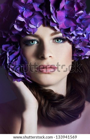 Woman with violet flowers. Woman with braid.