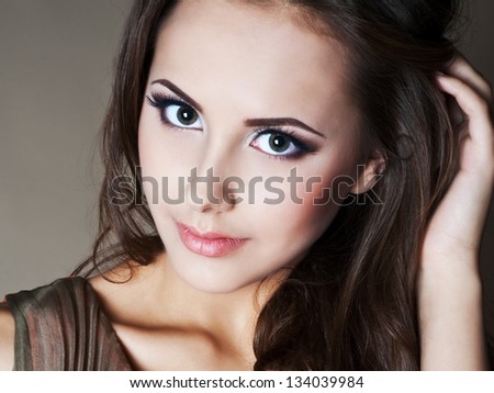Beautiful woman with evening make-up and evening hairstyle. Jewelry and Beauty. Fashion photo.